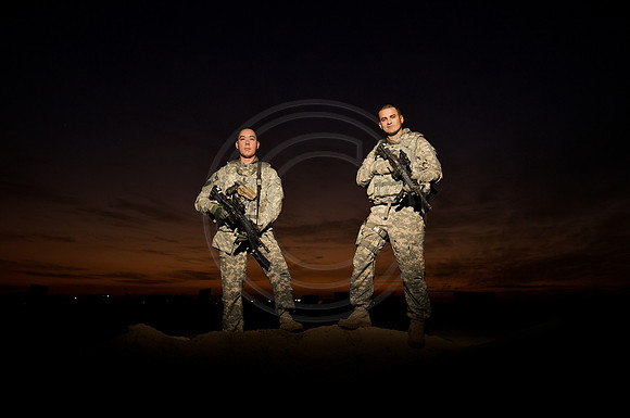 soldiers on a berm at sunset